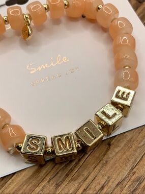 LC Lauren Conrad Peach Beaded "SMILE" Gold Tone Block Letter Bracelet